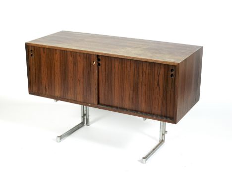 A rosewood and chrome sideboard, circa 1960s. With sliding doors pierced with circular apertures, enclosing two cupboards, on