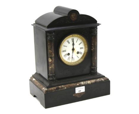 A Victorian slate and marble mantel clock with key. The white enamel dial with Roman numerals, flanked by marble columns and 