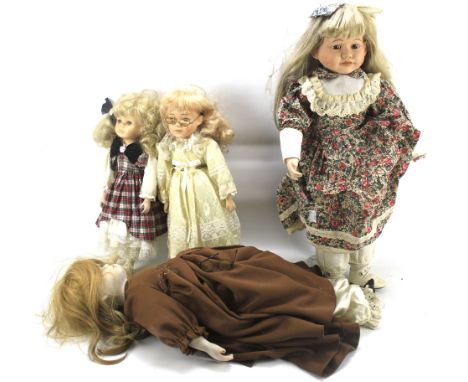 An assortment of vintage dolls. Some mounted on metal stands *