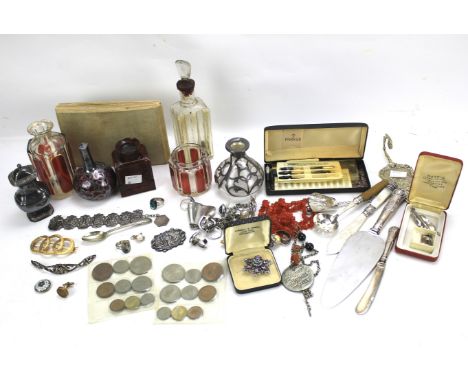 An assortment of collectables. Including glass bottles, silver, flatware, coins, brooches, pen nibs and jewellery
