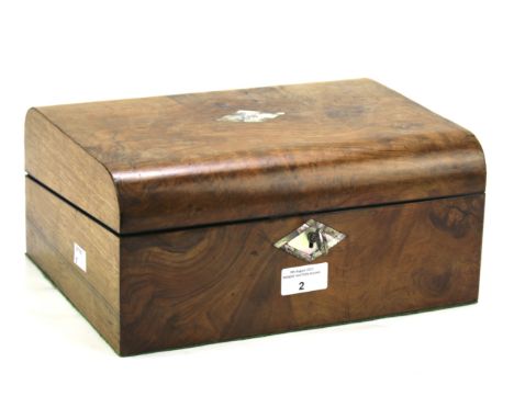 A Victorian burr walnut writing slope. The curved top and front with mother of pearl escutcheons, opening to reveal a blue le