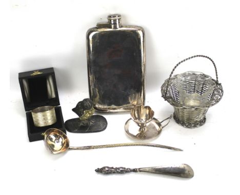 An assortment of silver and silver plate. Including a shoe horn, hip flask, basket napkin rings and a lead model of a bird