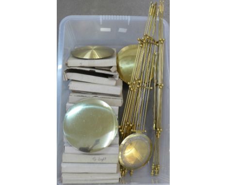 A box of brass clock pendulums and bars