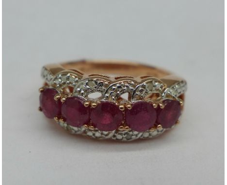 A silver gilt, ruby and diamond ring, L