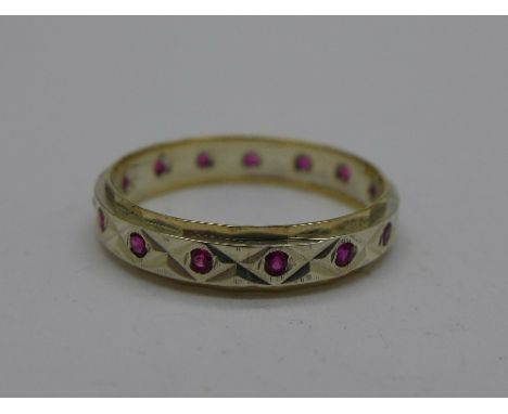 A 9ct gold and silver red stone eternity ring, R