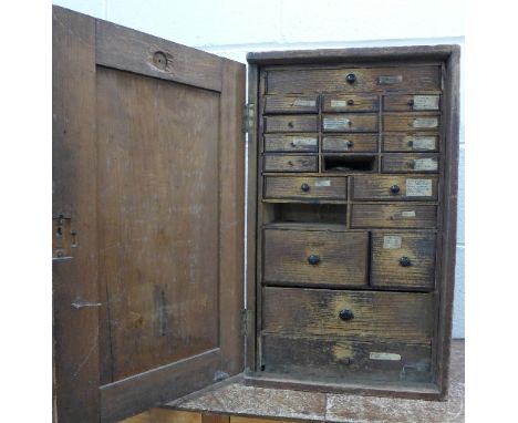 A watchmaker's chest with tools and parts, 58cm x 35cm