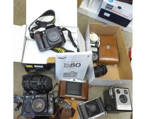 A collection of cameras including a Zenit 12XP,  Agfa, Voightlander, Kodak, a wide angle lens, one other lens, cased, a light