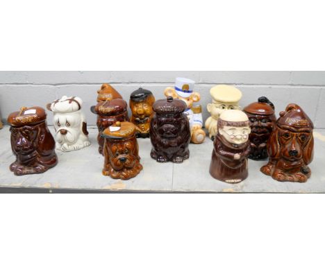 A collection of eleven novelty biscuits and sweets lidded jars, includes P &amp; K sad dog, Teddy bear majorette, monk and a 