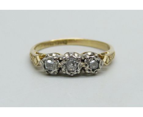 An 18ct gold and platinum set diamond trilogy ring, 2.9g, O 