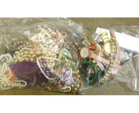 A collection of wristwatches, vintage brooches and earrings and a collection of bead necklaces 