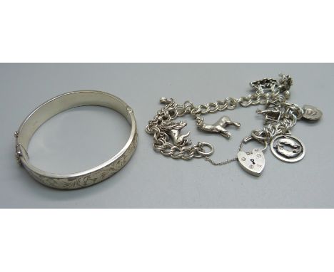 A silver bangle and a silver charm bracelet, 51g 