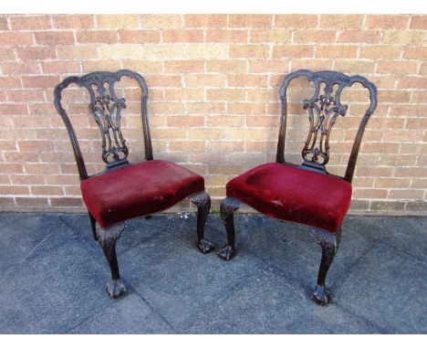 A PAIR OF CARVED MAHOGANY DINING CHAIRS in the Chippendale taste, with carved & pierced vase shaped splat backs, overstuffed 