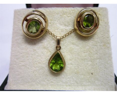 A PERIDOT PENDANT stamped '9ct', the pendeloque cut stone to a cord edge mount, 1cm long excluding the bale, on a light curb 