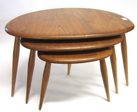 AN ERCOL LIGHT ELM NEST OF THREE PEBBLE TABLES all of graduated size, the largest table 65cm wide, 40cm high