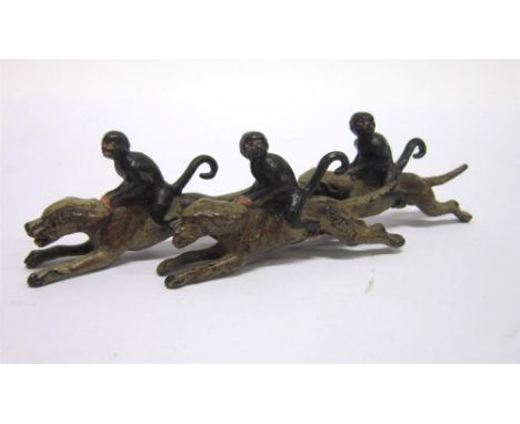 A COLD PAINTED BRONZE GROUP OF THREE MONKEYS RIDING THREE FOXHOUNDS 13cm wide