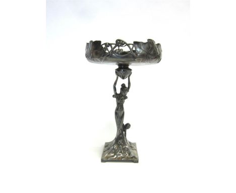 A WMF ART NOUVEAU COMPORT the female figural column holding aloft a leaf and berry openwork bowl, to a swept base modelled wi
