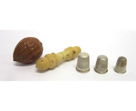 A TREEN THIMBLE CASE carved as a walnut; a needle case, possibly vegetable ivory, with acorn style ends, 7.5cm long; and four