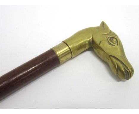 A SECTIONAL WALKING STICK with detachable brass horse head terminals, 93cm long