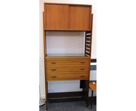 A STAPLES LADDERAX TEAK WALL UNIT comprising of two ladders, one shelf, cupboard with sliding doors and glass shelf and a set