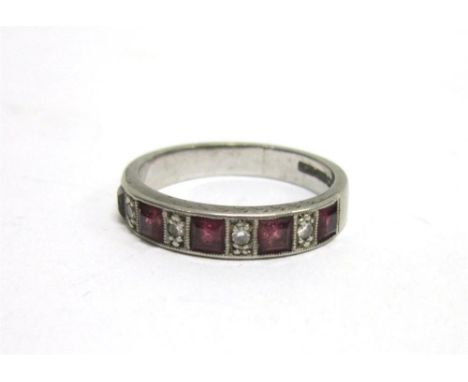 A DIAMOND AND RUBY 18 CARAT WHITE GOLD half eternity ring, the five square cut rubies alternate set with four small brilliant