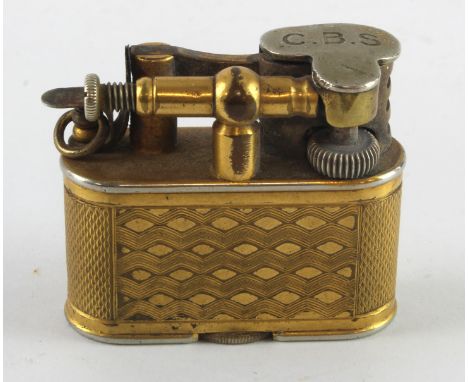 Dunhill. A Dunhill gold plated engine turned lighter, made for Harrods, marks to base, height 36mm, length 42mm approx.