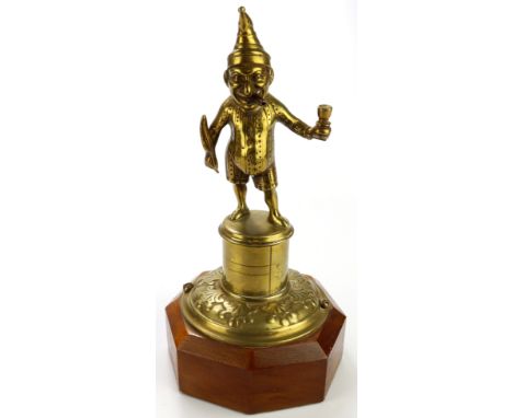 Brass Mr Punch table / counter lighter, mounted on an octagonal plinth, total height 24cm approx.