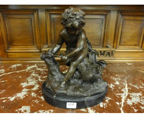 A bronze figure of Cupid on a marble base