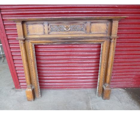 An Art Nouveau oak chimney piece