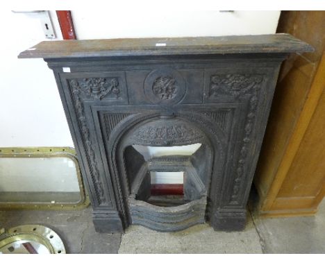 An Art Nouveau style cast iron fire surround