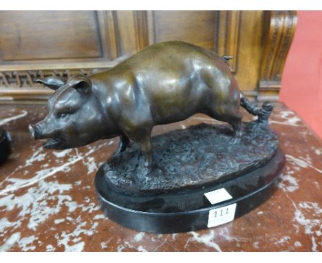 A bronze figure of a pig on marble plinth