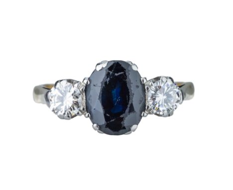 A sapphire and diamond ring. The central oval cut sapphire approx. 1.91 cts. Flanked by two brilliant cut diamonds, totalling