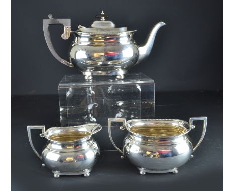 A silver tea service with gadrooned rim, on ball feet, Sheffield 1932, makers mark JT&Co in shield, 1060grs (3)