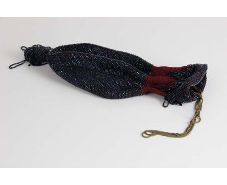 A glass beaded draw string bag, of money purse form with large ball tassel drop, the whole beaded in iridescent 'scarab' bead