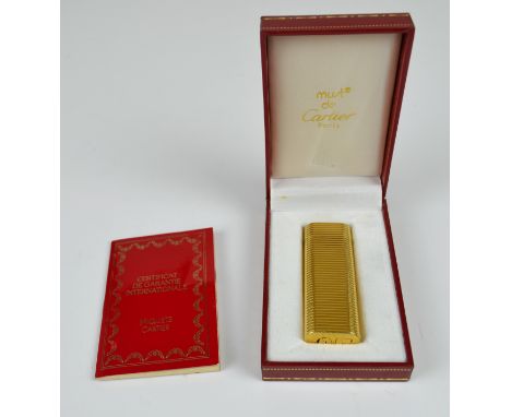 Cartier - A must de Cartier horizontal gold plated lighter, marked Cartier Paris,2655N Swiss made, in working order, in origi