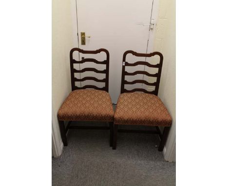 A pair of oak framed ladder back chairs with salmon coloured upholstered seats with plain legs and stretchers
