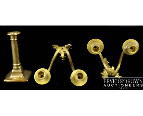 A pair of cast brass two light wall sconces, of torchiere form surmounted by summer flowers; and a candlestick with pusher, 1