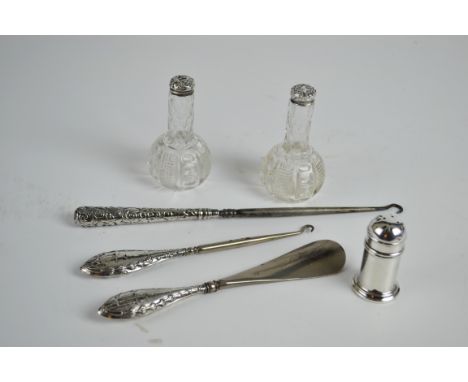 A pair of silver mounted cut glass bottles together with a silver pepperette with blue glass liner; two silver handled button
