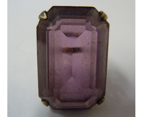 A vintage silver and cut cornered step cut amethyst coloured glass dress dress ring, set in white metal