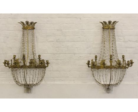 A pair of large 19thC French Empire nine light wall sconces, with facetted glass drops, decorated with dolphins and cherubs, 