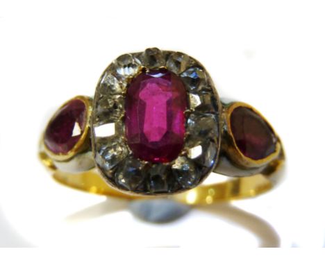 A pretty early 19thC ruby, diamond and gold dress ring, c1830, the central oval shaped ruby within a surround of small old cu