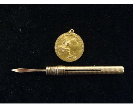 An antique rose coloured gold engine turned toothpick case and a gold medallion (2)