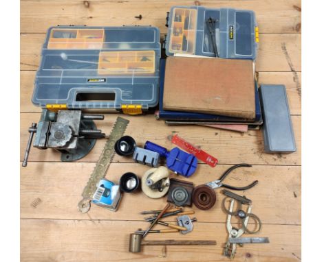 Group of watchmakers tools to include a staking tool, Ronda and DCN catalogues, mainspring and barrel gauge, jewel rubbing to