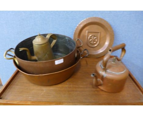 Two copper cooking pots, a copper kettle, a brass kettle and a copper wall plaque