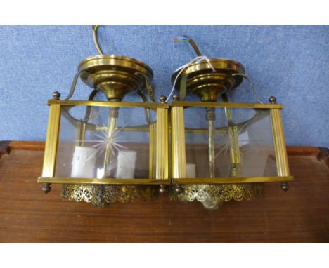 A pair of brass lantern style hanging lights
