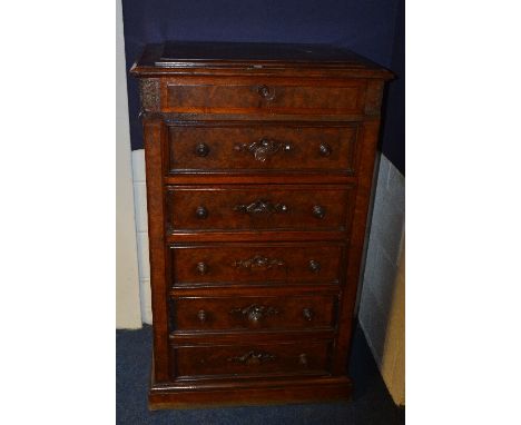 A 19th century walnut Wellington style chest of drawers, the hinged caddy top enclosing sectioned maple lined interior, above