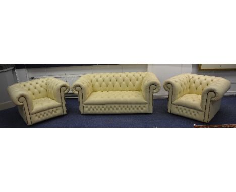 A Chesterfield club style leather sofa with pair of matching armchairs, in ivory coloured Connolly hide, ex Rolls Royce showr