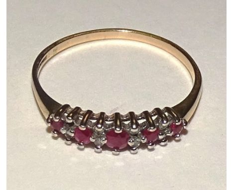 A 9ct gold ruby and diamond ring, the five graduated round cut rubies interspersed by eight diamond chips (one missing), stam