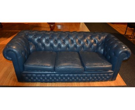 A blue leather buttonback club Chesterfield style three seater sofa, 65cm high x 20cm wide