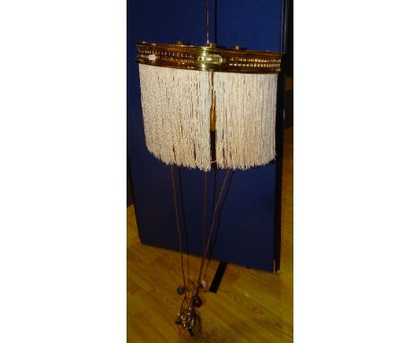 A vintage brass rise and fall ceiling light, with later fabric tassels and lead filled pulley, 28cm high x 42cm diameter