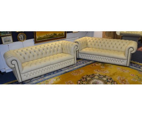 A pair of Chesterfield club style three seater leather sofas, in ivory coloured Connolly hide, ex Rolls Royce showroom, 60cm 